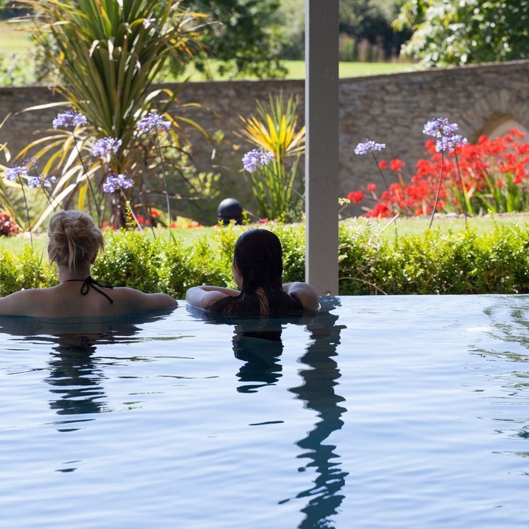 Two people relaxing in a spa pool in Cornwall