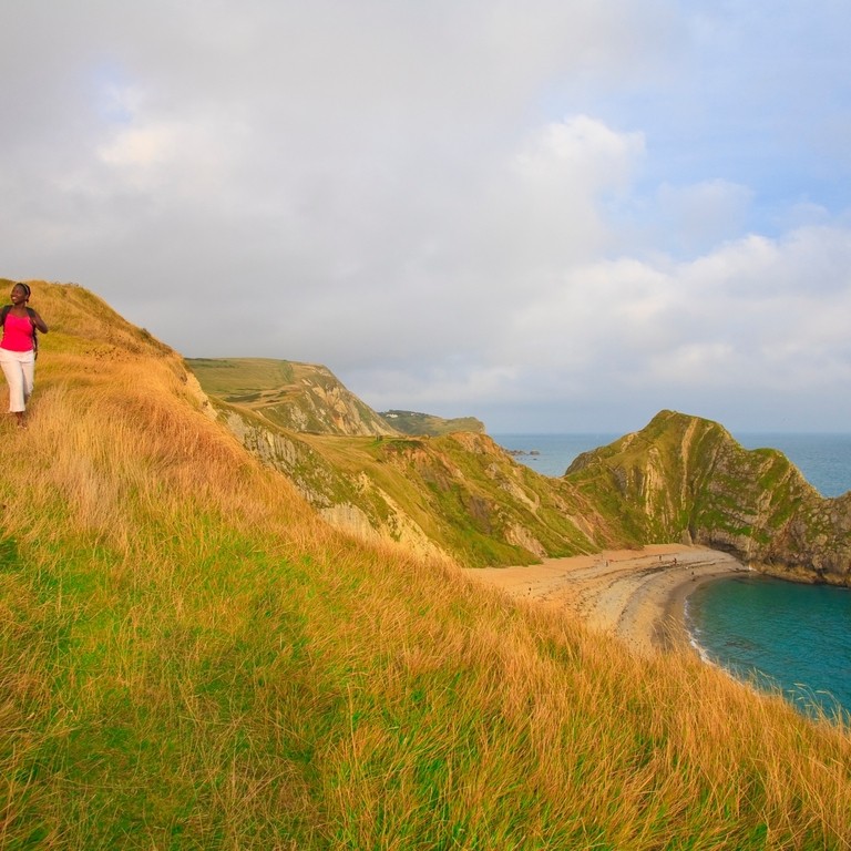 A couple walking on the clifftop in Dorset