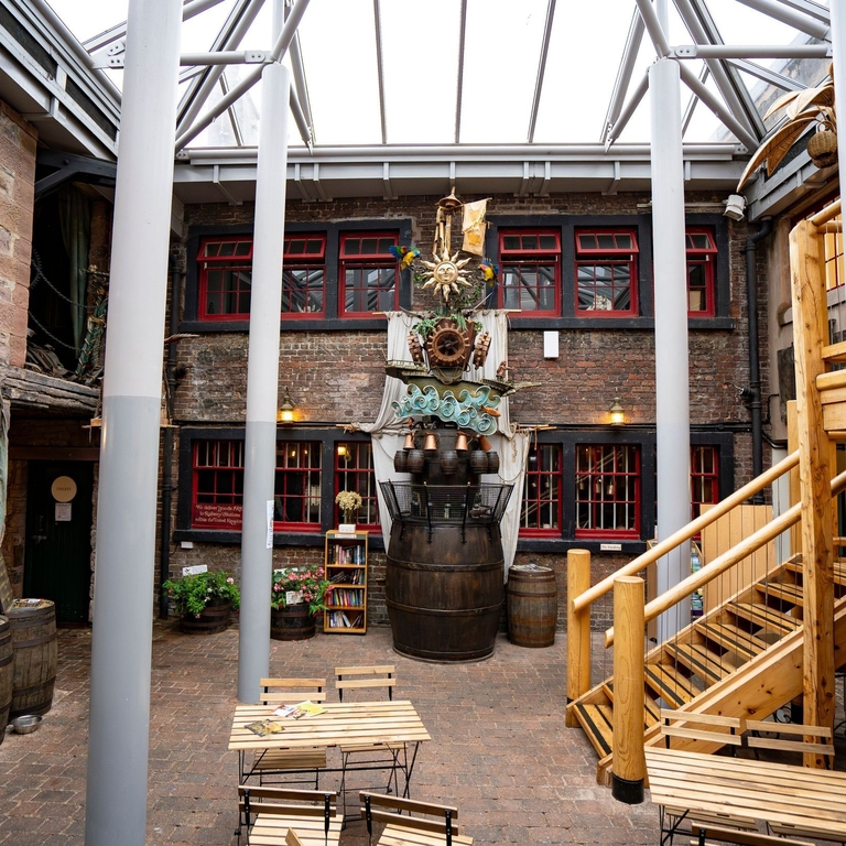 Chairs, tables and a sculpture at an internal courtyard