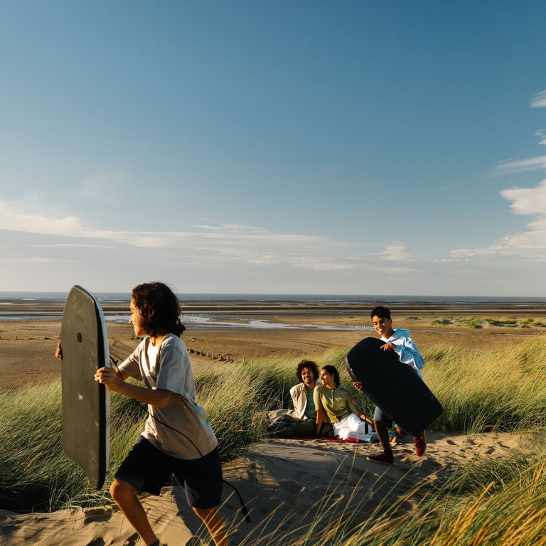 A family enjoy a day out in the sand dunes