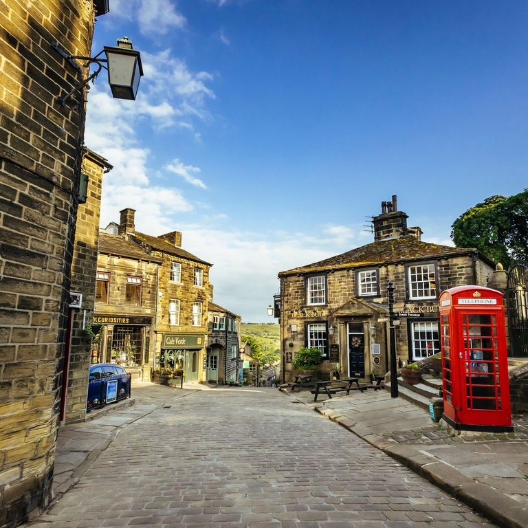 A view down a traditional cobbled street with a telephone box in view