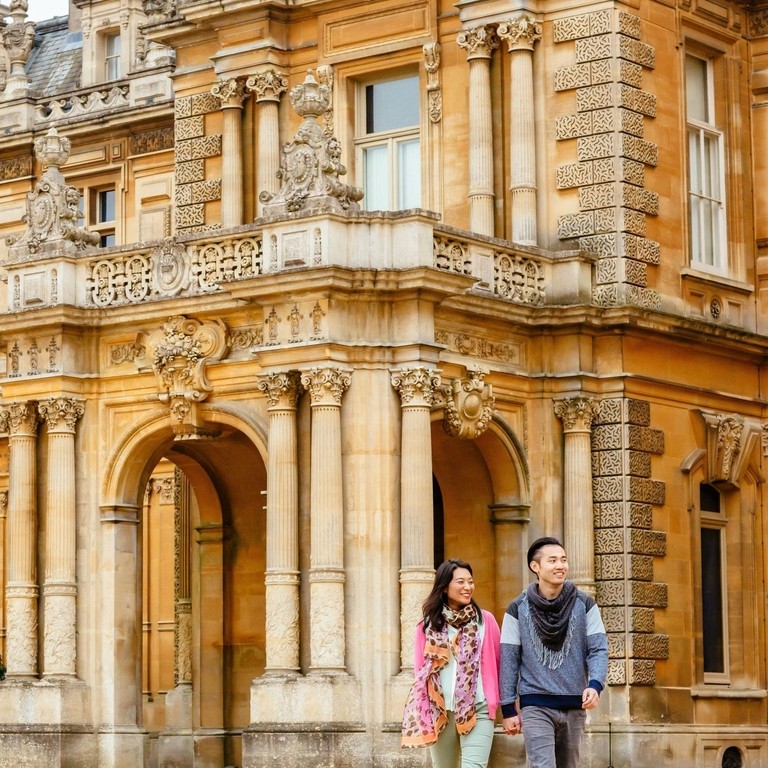 Couple walking outside a stately home