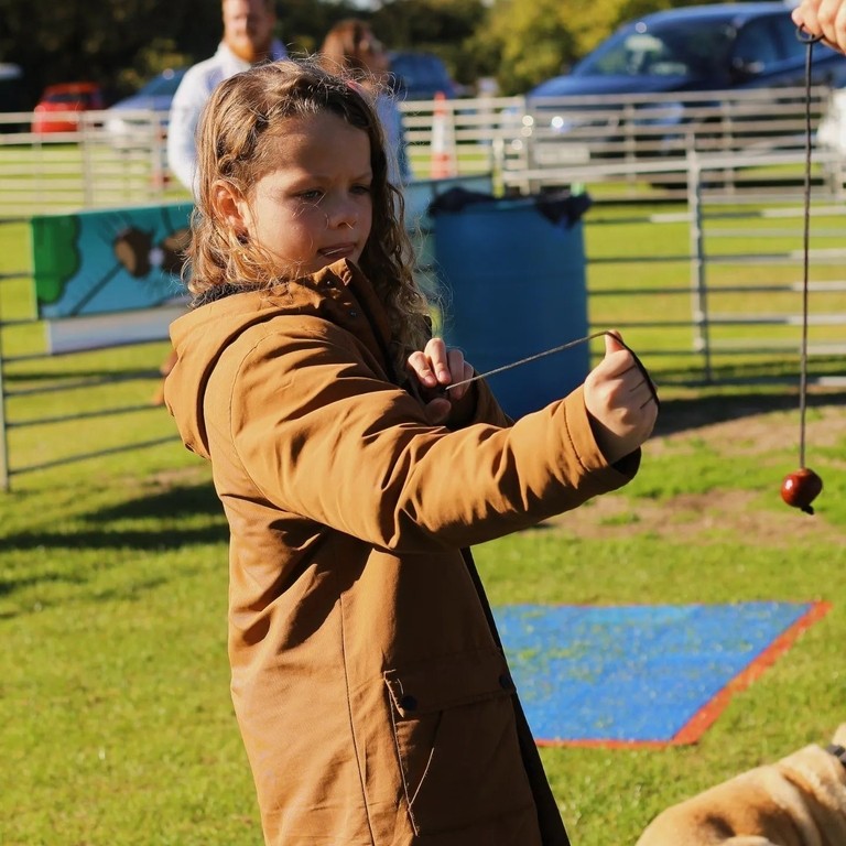 A child playing with a conker at the World Conker Championships in Northamptonshire