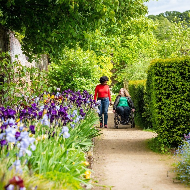 Two women in a Walled Garden, one using a wheelchair
