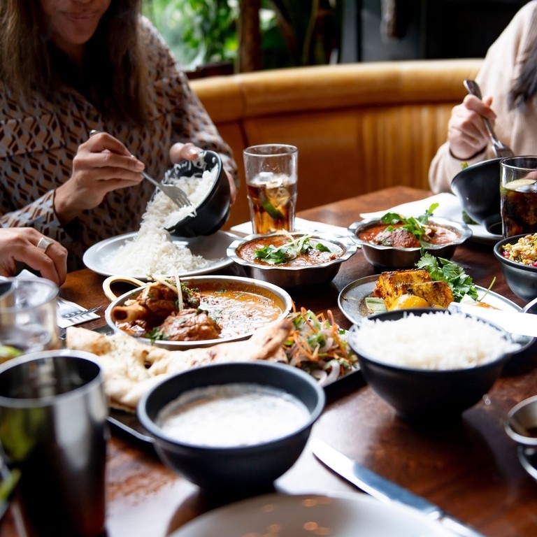 A group of people eating a meal at a table in a restaurant in Birmingham, West Midlands
