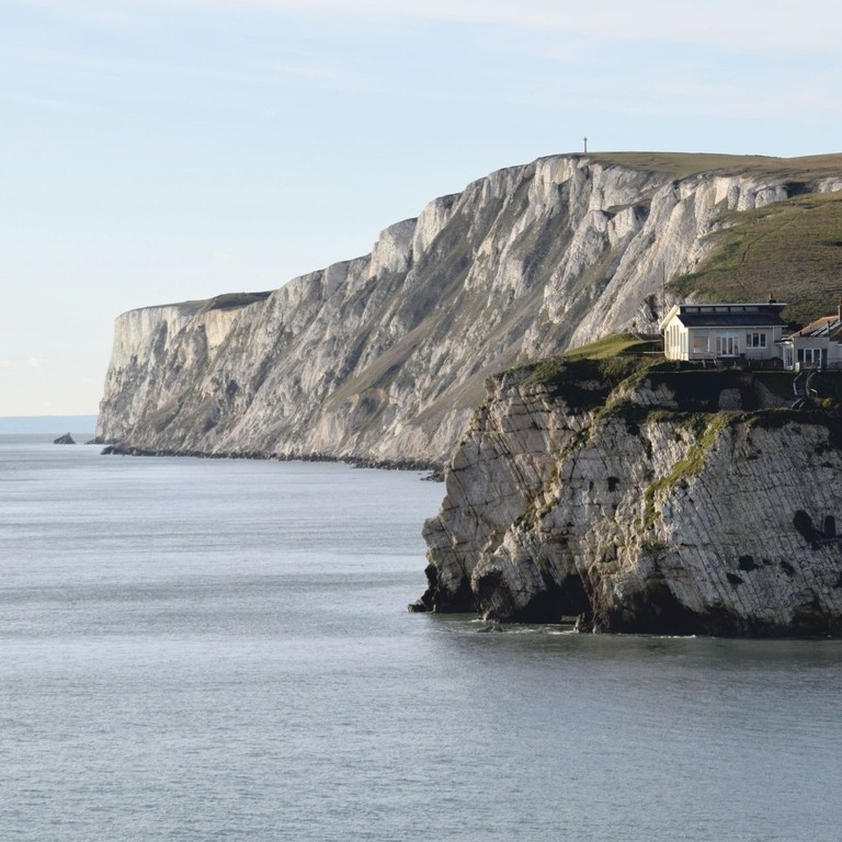 Houses on chalk cliffs overlooking the ocean