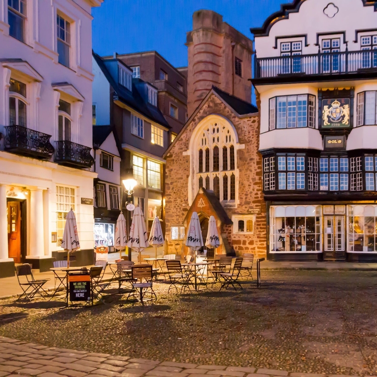 A quaint English town square in the evening.
