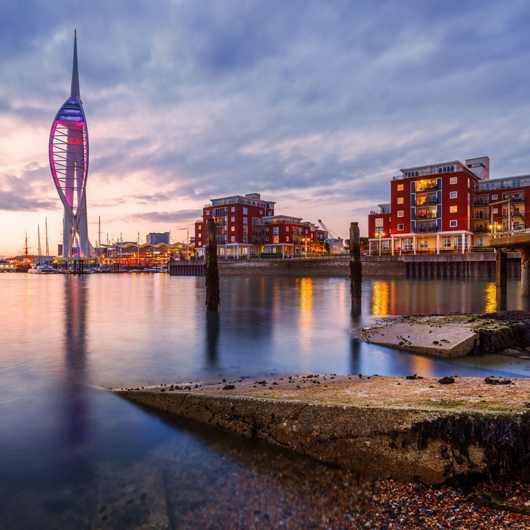 Harbour with a Tower lit up at dusk
