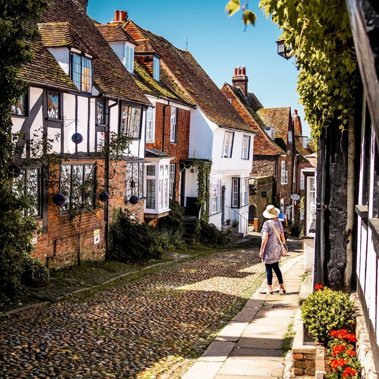 Woman looking down a narrow village street
