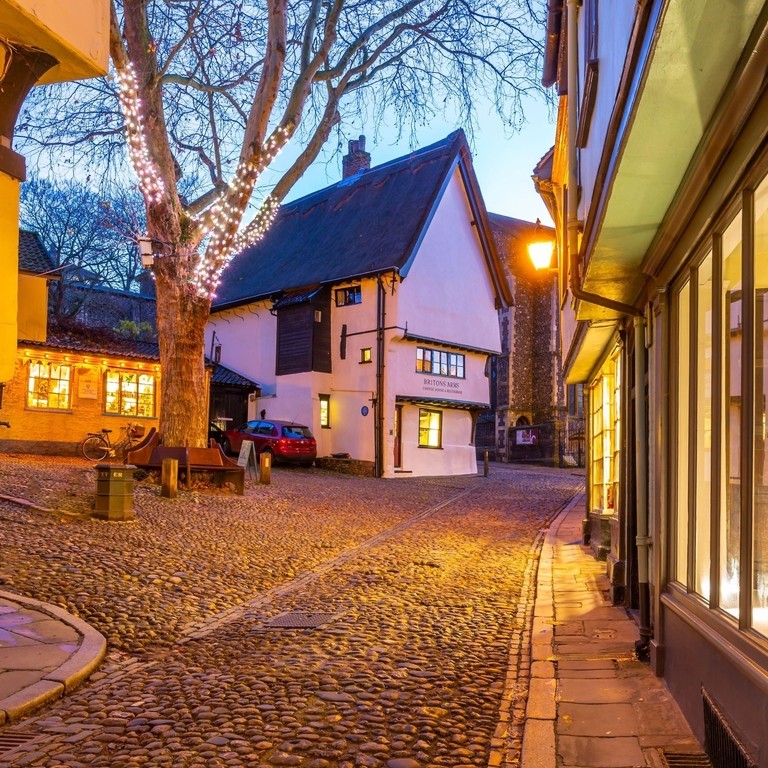 A pretty village square with cobbled streets at dusk