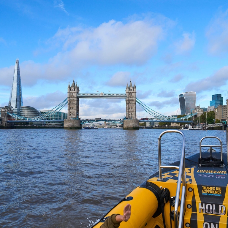 Group of people on board a speed boat on a city river