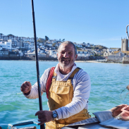 Fisherman in a fishing boat in the sea