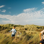 A family enjoy a day out in the sand dunes