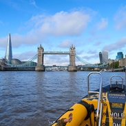 Group of people on board a speed boat on a city river